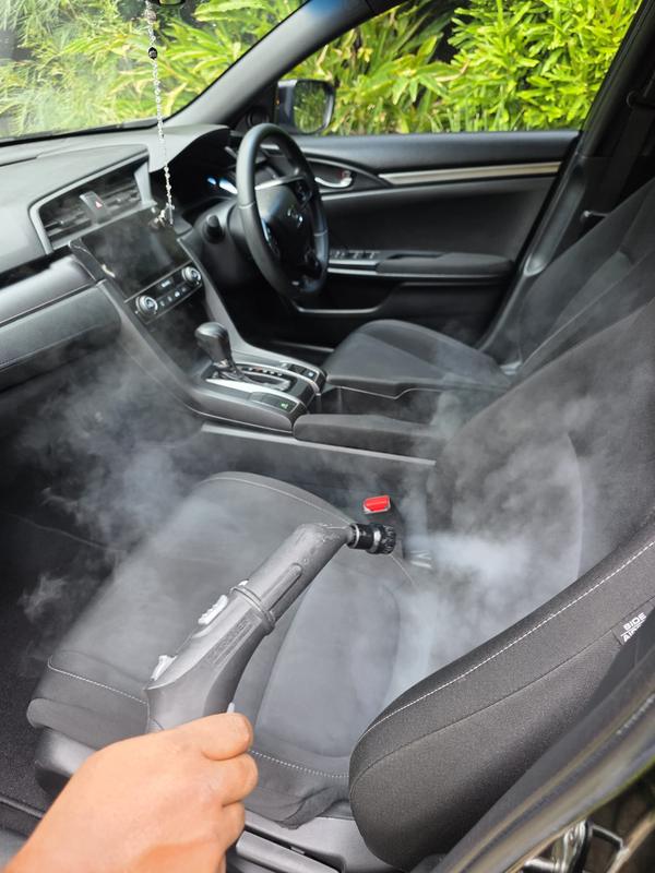 Steam cleaner lifting grime from a Honda Civic seat